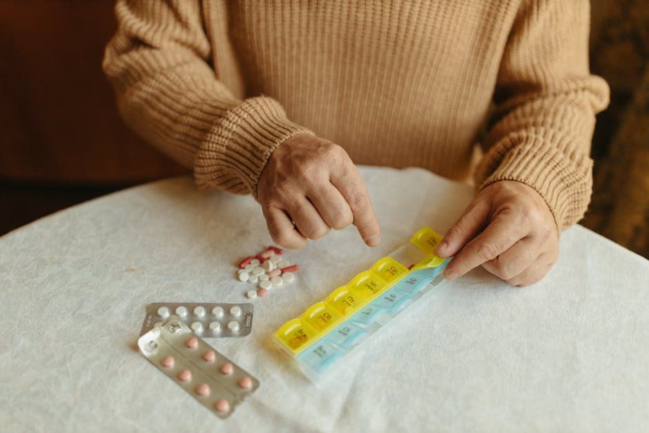Organised medication bottles and a pill organiser for an elderly patient