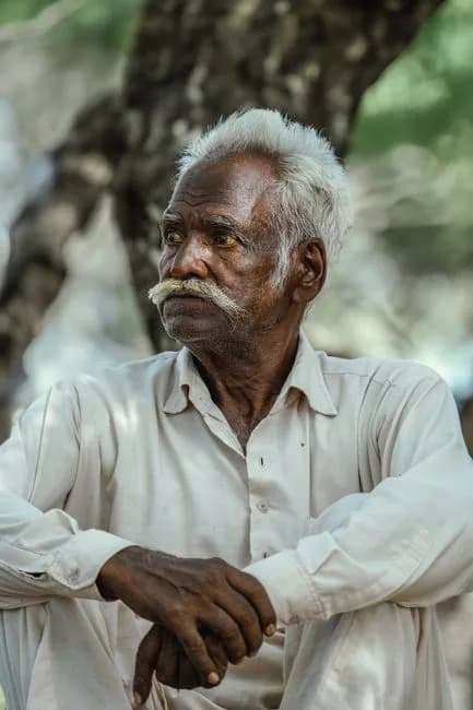 Elderly Indian man gazing thoughtfully into the distance