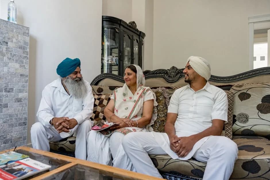 Indian family having a serious conversation together at home