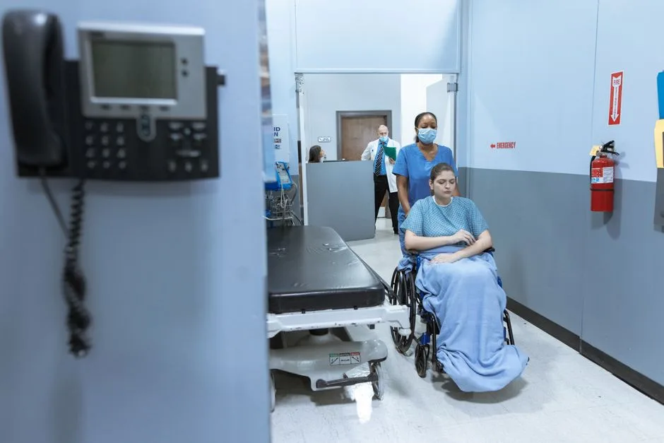 Patient being wheeled through a hospital emergency corridor