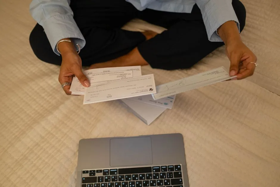 Hands sorting hospital bills and insurance paperwork