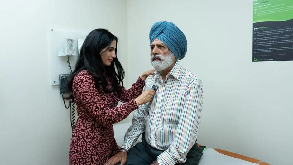 Doctor checking an elderly patient with a stethoscope