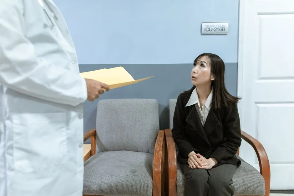 Person waiting worriedly outside an ICU ward door