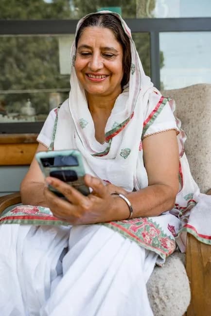 Indian woman in traditional dress looking at her phone