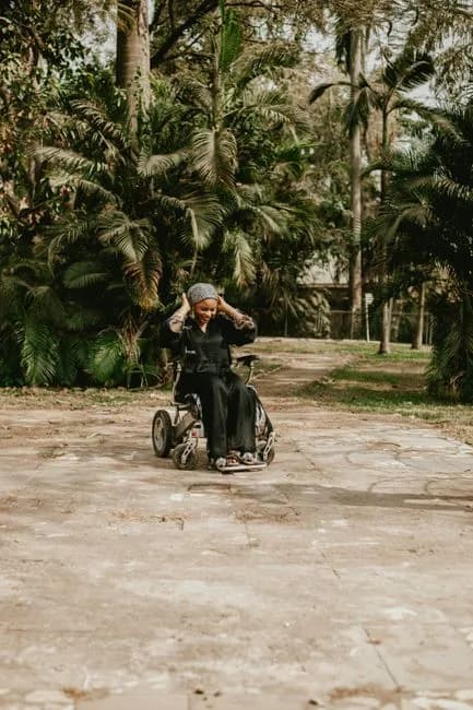 Person using a motorized wheelchair outdoors