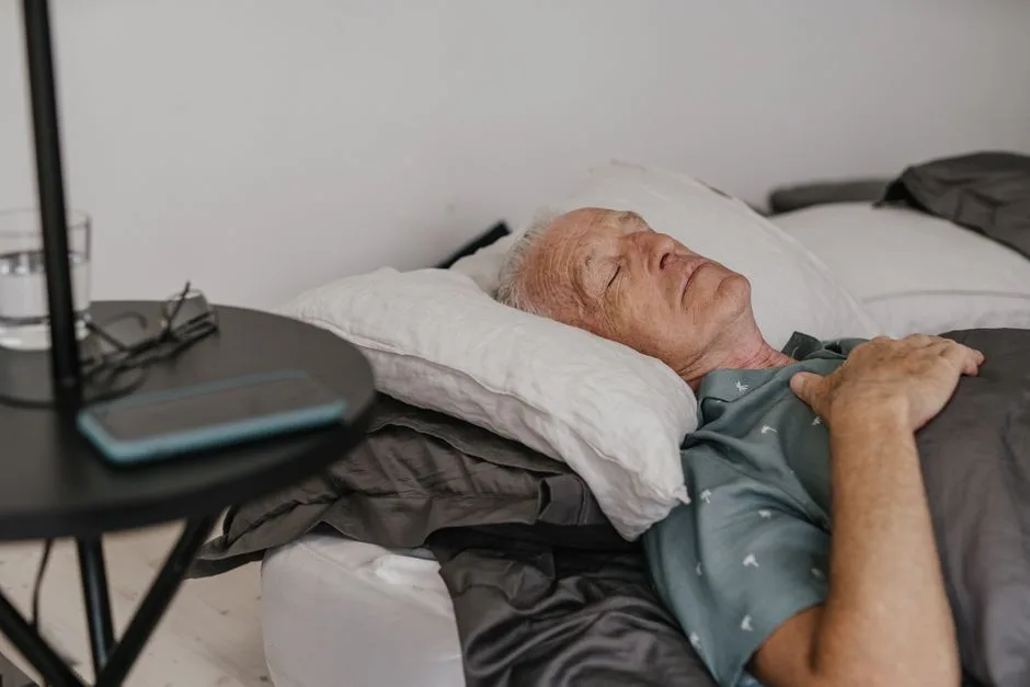 Elderly man sleeping in bed