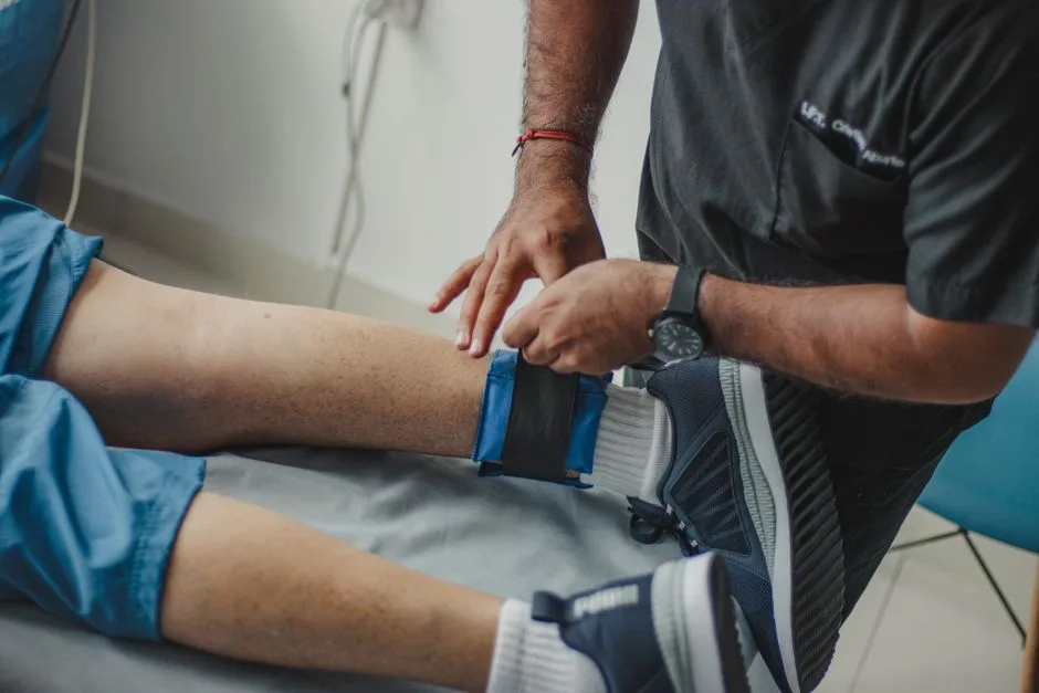 Physiotherapist assisting a patient with leg rehabilitation
