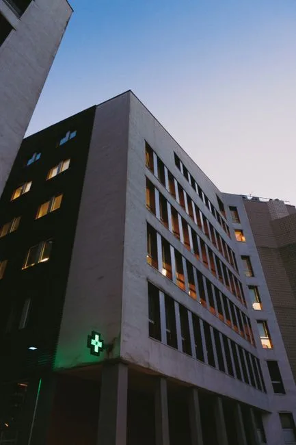 Hospital building with an illuminated medical cross sign