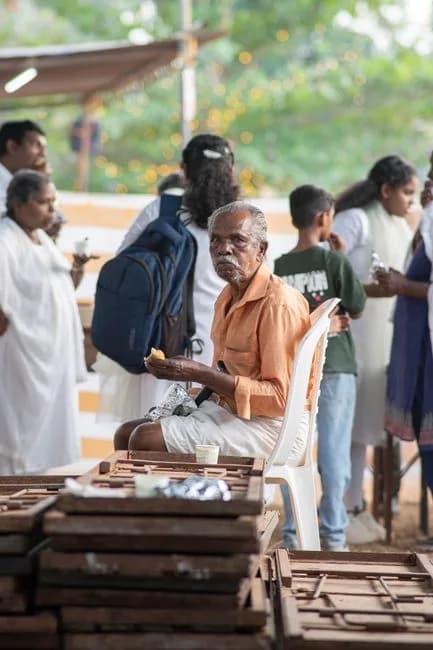 Elderly man enjoying a social gathering outdoors