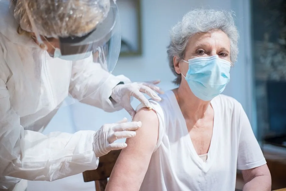 Elderly patient being prepared for a vaccination